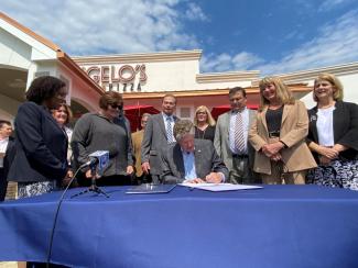 Bill signing in front of Angelo's